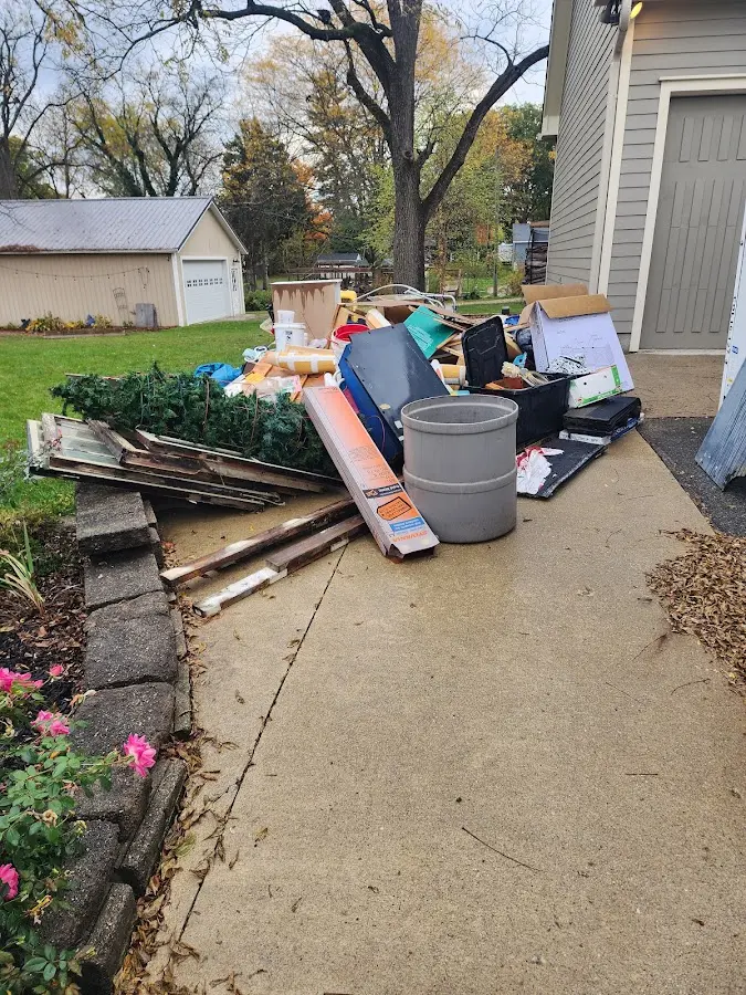 Dumpster being loaded with debris for 12 Yard Dumpster Rental in Sugarloaf